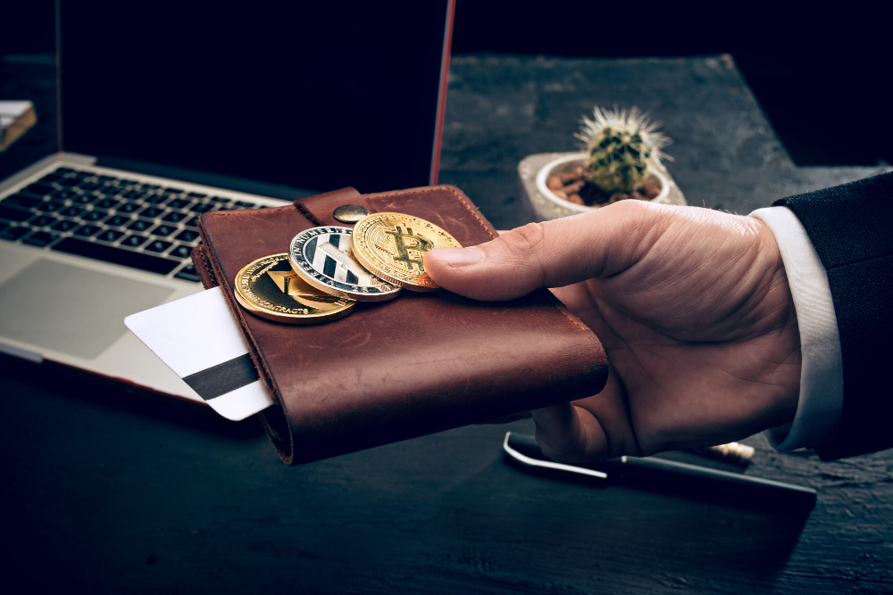 Man holding wallet with cryptocurrency bitcoins and card